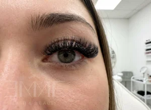 bottom lash extensions on green eyes at EMME Lash and Beauty salon showing full lash look