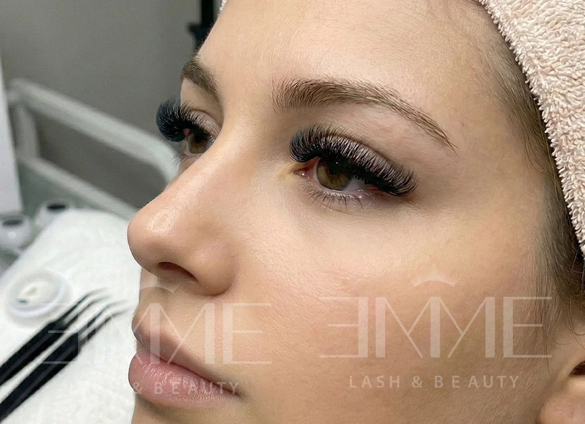 a woman having volume eyelash extension at emme lash bar
